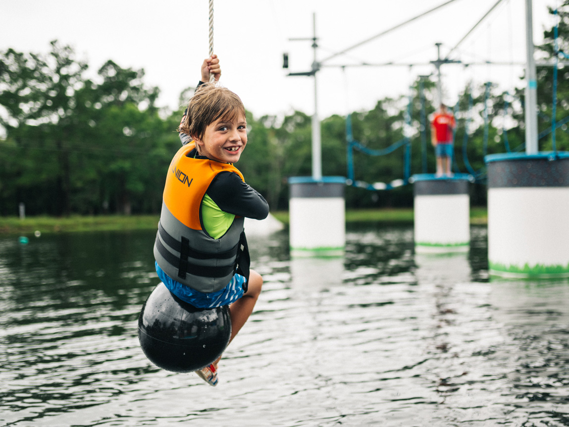 Kid slides down into the lake